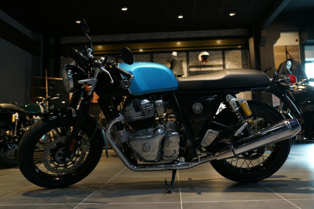 A sleek blue motorcycle parked inside a showroom with a stylish design.