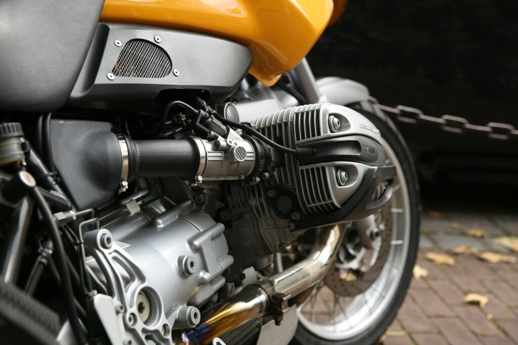 Detailed view of a motorcycle engine with a vibrant yellow body.